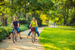 © Lucky Fenix - Happy family. Smiling father and mother with kid on bicycles having fun in park..