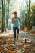 © Microgen - Woman Exercising Outdoors in The Fall