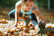 © Microgen - Woman stretching in the park, in the fall.