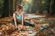 © Microgen - Woman stretching in the park, in the fall.