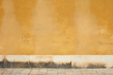 Sticker - Yellow old faded wall and empty sidewalk with stone detail