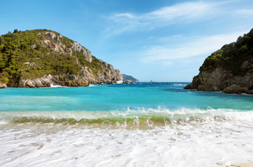 Poster - Beautiful sandy beach and waves in a bay at Paleokastritsa in Corfu, Greece