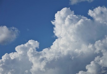 Amazing cumulus clouds and sunlight on the background of clear blue sky, Summer in GA USA.