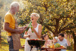 © ivanko80 - Family grilling meat on a barbecue