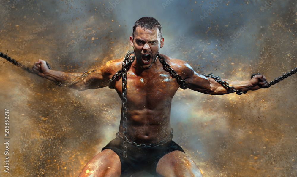 Muscular man slave in chains in a sand storm, the prisoner - obrazy, fototapety, plakaty 