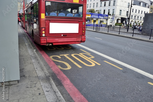 Fotografie, Tablou Double Decker red bus is running on road in London