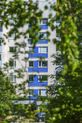 Sticker - Apartment building among the foliage in the summer