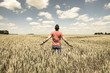 © peterotoole - Young Man Standing in a Wheatfield with his Arms Stretched Out