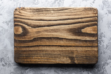 Wall Mural - Old oak wood board on rustic concrete table. Food photography