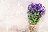 Fototapeta Lawenda - Lavender flowers, bouquet on rustic background, overhead.