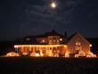 © Jack Aiello - Christmas House lit up with white lights, moon in the sky
