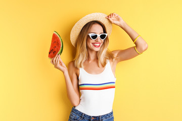 Pretty young woman with juicy watermelon on color background