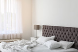 Fototapeta  - Soft white pillows on comfortable bed indoors