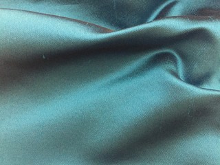Woven texture of silk fabric or yarn beige color changeable for background. Draped folded satin.