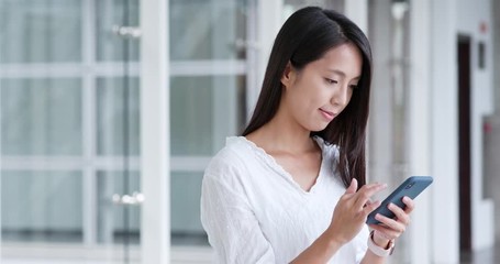 Sticker - Woman sending sms on cellphone in university campus