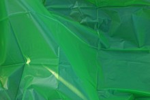Green Plastic Texture Of A Piece Of Crumpled Cellophane