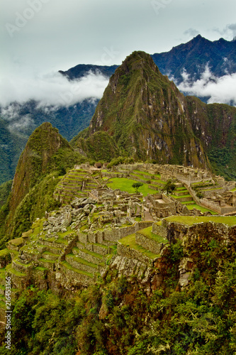 Fotografie, Obraz Vertical Image of Machu Picchu with Hauyna Picchu looming- an explorers and adve
