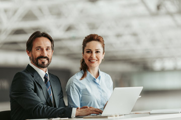 Portrait of beaming unshaven man and happy girl working with notebook computer