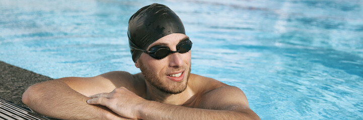 Sticker - Swimmer athlete man wearing sport goggles and swim cap in indoor swimming pool portrait panoramic banner crop. Portrait of sporty active person lifestyle.