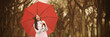 Autumn rain woman walking in park with red umbrella enjoying outdoor forest. Panoramic banner. Asian girl with yellow foliage background.