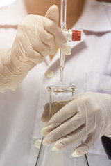 Wall Mural - close up of hands are holding the burette and flask in chemistry laboratory.
