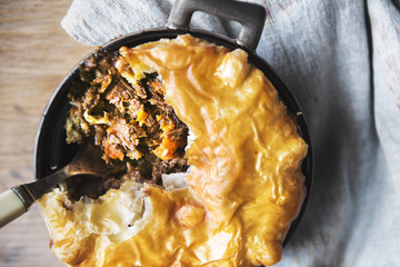 Top view of meat pie on wooden table