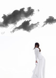 Fototapeta Konie - Smiling girl posing outside in long white dress