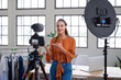 Leinwandbild Motiv Social media entrepreneur recording daily vlog in studio