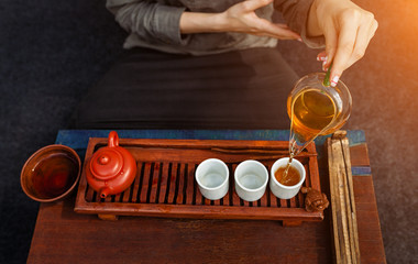 Chinese tea ceremony is perfomed by tea master in kimono