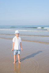 boy preschooler walking on the ocean