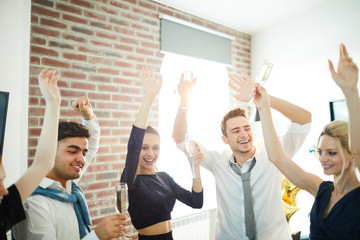 Poster - Happy young friends in smart attire dancing with raised hands while enjoying home party