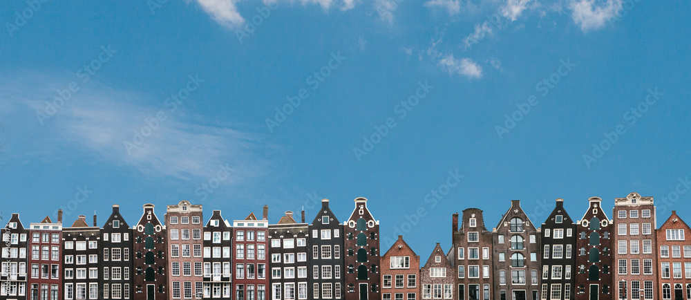 Obraz na płótnie Panorama or panoramic view. Traditional houses in Amsterdam in the Netherlands in a row against the blue sky. w salonie