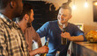 © Prostock-studio - Happy young friends drinking alcohol beverage in pub