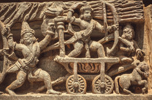 South Indian Temple Relief With Battle Scene. Warriors With Bow And Arrows Fighting On Wall Of Hindu Structure From 12th Century, Halebidu, India