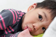 close up Little Asian boy sucking thumb.