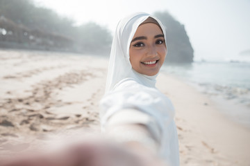 woman in white scarf taking selfie