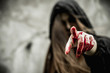 Asian woman dress black as Grim Reaper of death and point the finger at you in Halloween festival. Halloween concept.