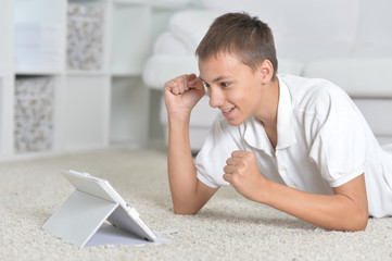 Wall Mural - Portrait of a young boy with the tablet