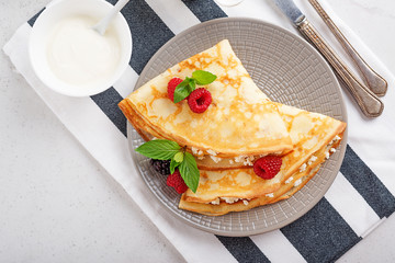 Wall Mural - Crepes, thin pancakes with fresh raspberry,blackberry and cottage cheese. top view