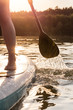 Partial view of stand up paddler at sunset