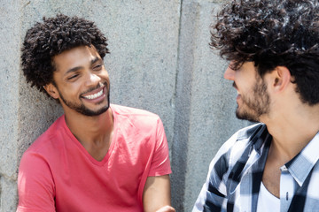 Happy african american man talking with friend