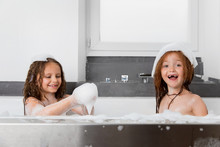 Happy Girls In Soapy Bubble Bath Playing With Suds