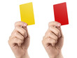 Male football (soccer) referee hand holding yellow and red cards, isolated on white background