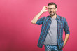© denis_vermenko - People and positive emotions concept. Delighted glad bearded male with stylish hairdo, dark beard, keeps eyes shut, smiles joyfully, dressed in casual, isolated over pink background