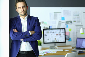 Fototapete - Portrait of young designer in front of laptop and computer while working.