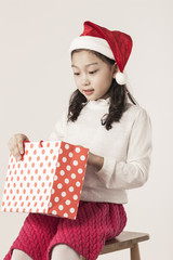 A asian girl hand hold a christmas gift on the white background.