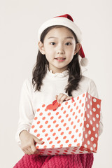 A asian girl hand hold a christmas gift on the white background.