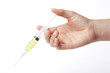 © dohee - hand hold a yellow syringe isolated white.