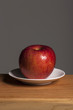 © dohee - fresh fruits(red apple) on the wood table, grey background.