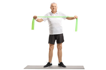 Sticker - Mature man exercising with a rubber band